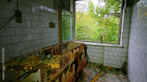 Footage captures the eerie, decaying interior of the abandoned Sanitary and Epidemiological Station in Pripyat, Ukraine, located within the Chernobyl Exclusion Zone. The scene features rusted equipmen