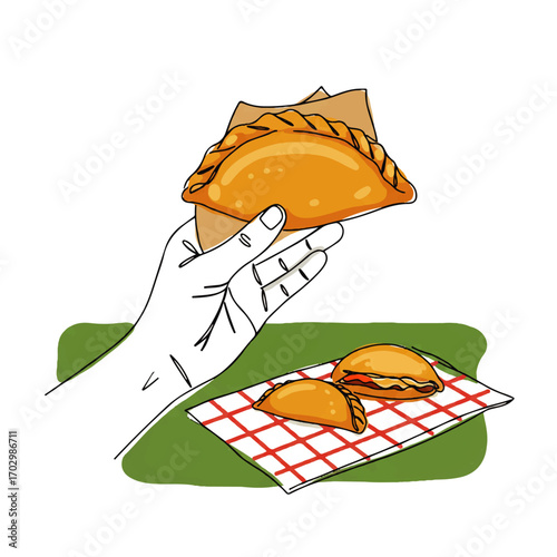 Delicious empanadas offered by hand on checkered napkin, perfect for culinary inspiration