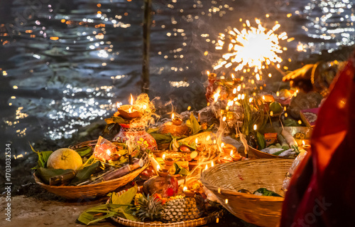 festive chhath puja celebration with offerings basket and sparkling lights at riverbank