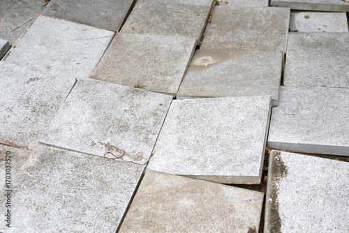 Fotografi Concrete sidewalk texture, cracked and uneven sidewalk tiles