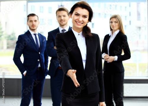 Portrait of woman with an open hand ready to seal a deal
