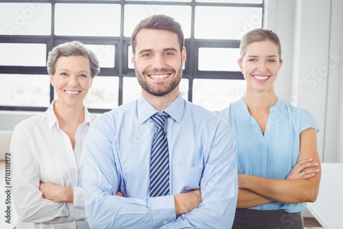 Cheerful business people with arms crossed