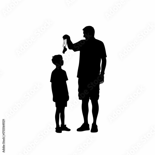 Silhouette of grandfather sharing medals with grandson celebrating achievement