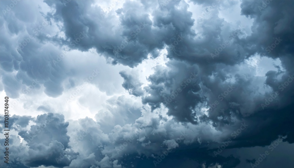 Obraz premium Dramatic Storm Clouds Filling the Sky in Shades of Gray and Blue Weather Phenomenon