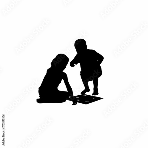 Silhouette of siblings enjoying a board game together