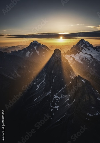 Dramatic Mountain Sunset with Golden Light and Long Shadow, Aerial View of Snow-Capped Peaks and Alpine Landscape at Golden Hour