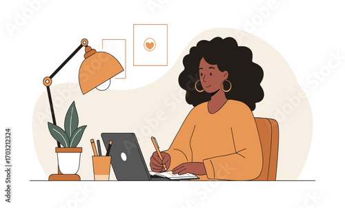 A young black woman with curly hair sits at her desk, working on her laptop and writing in a notebook in a bright, modern, minimalist home office.