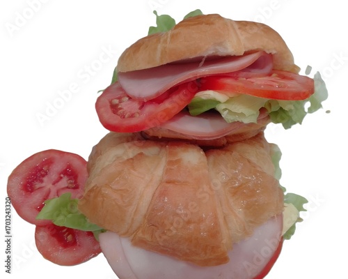 Stacked Ham Croissant Tower: A delicious towering stack of fresh ham croissant sandwiches, layered with ripe tomato and crisp lettuce.