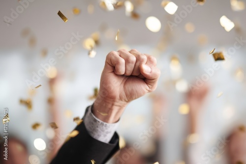 holding success hand sign high in the air