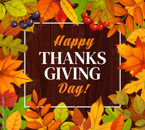 Thanksgiving day poster with orange, yellow and green autumn leaves and berries in decorative frame on a wooden background. Happy Thanks Giving holiday vector greeting card with fallen forest foliage