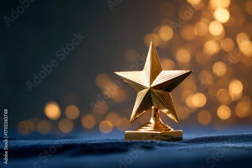 Golden star award trophy on dark fabric with shimmering warm bokeh lights in the background symbolizing success and achievement celebration