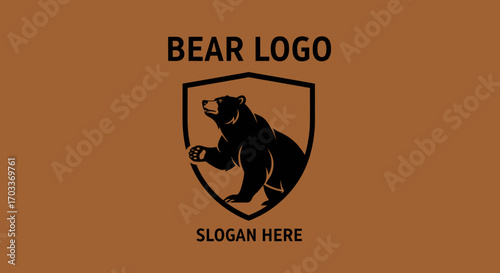 A black silhouette of a bear standing within a shield emblem, with "BEAR LOGO" and "SLOGAN HERE" text on a brown background.