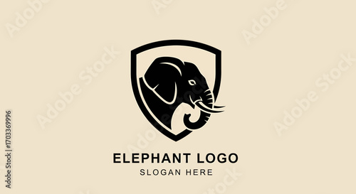 A stylized black silhouette of an elephant head enclosed within a shield-shaped emblem, presented on a neutral background.