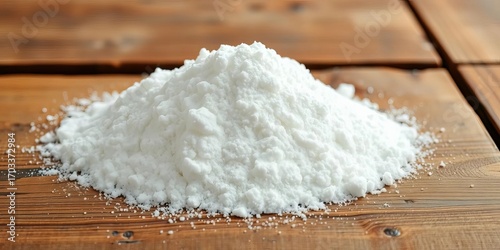 A mound of baking soda sits on a rustic wooden table, culinary, recipe