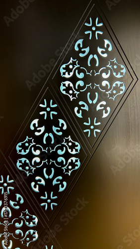 Fotografie Ornamental Laser-Cut Wall Panel With Geometric Floral Motif, Backlit In Blue, Ca