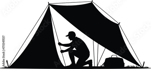 Person setting up tent outdoors silhouette kneeling