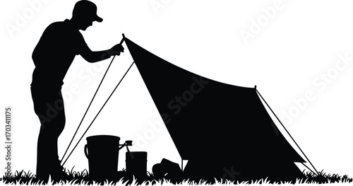 Person setting up tent with buckets on grass silhouette