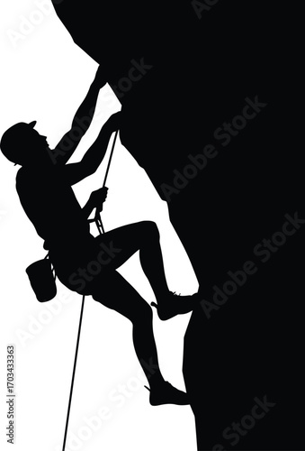 Silhouette of climber ascending rock face rock climbing