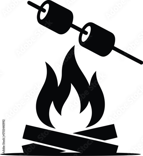 Marshmallows roasting over campfire flames logs