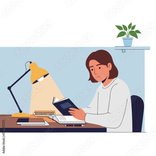 Woman reads book illuminated by lamp at home. Enjoyable moment reading book and gaining knowledge near laptop in home workspace. Home reading concept for knowledge and learning.