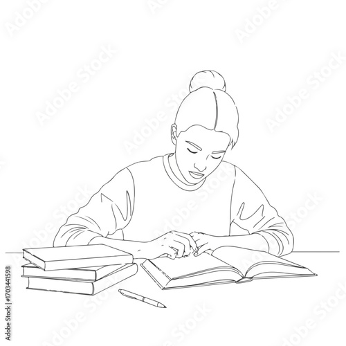 Reading book at laptop home, woman studies with book in room. Reading book with laptop at home as she focuses on pages next to pile of books and pen. Depicts concept of reading book in quiet space.