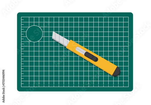 A utility knife rests on a selfhealing cutting mat