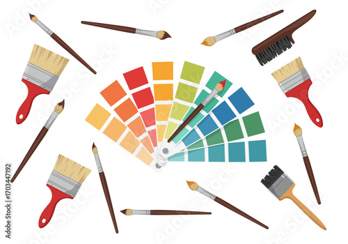Assorted paintbrushes surround a color palette of reds yellows greens and blues