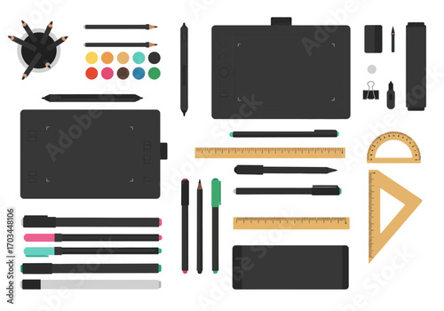 Overhead shot of scattered art supplies pens pencils digital tablets paint pallet rulers and other tools