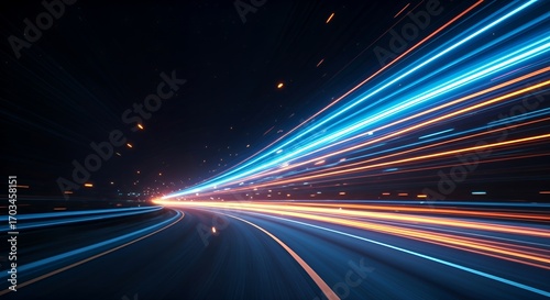 Dynamic neon light trails in blue and orange creating a sense of speed and motion on a dark road. Futuristic abstract background design concept for technology, energy, and fast movement.