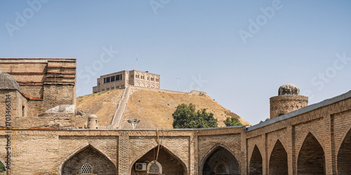 Landscape view of ancient madrasa kunha with Hissar aka Hisor fortress in background, historic medieval landmark of Tajikistan	
