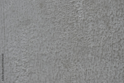 Calm gray abstract background with textured, rough wall surface. simple, raw pattern on concrete material shows minimalist detail