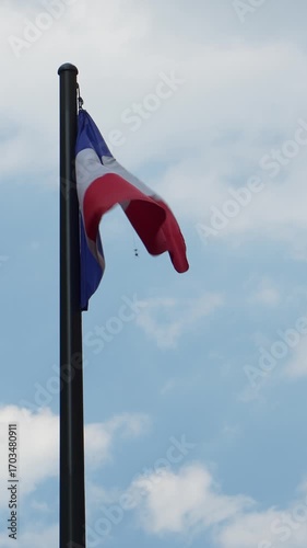 French flag waving in the wind on a cloudy day