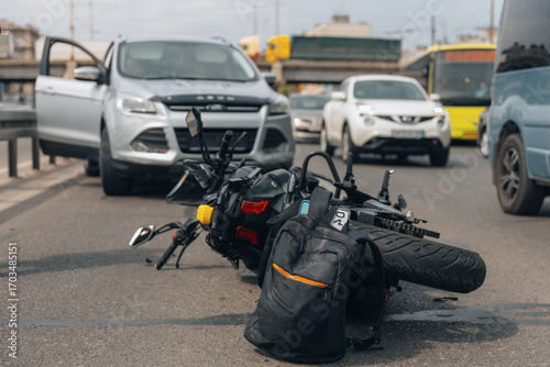 The motorcycle lies on the sidewalk after a ride. Serious accident. Accident, close-up. Lost control and fell. Driving hazards. Collisions with another vehicle.