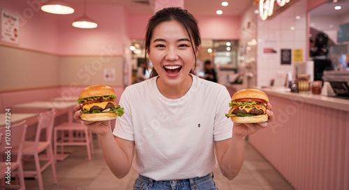 influencer holding two burgers while making a excited face at a burguer house