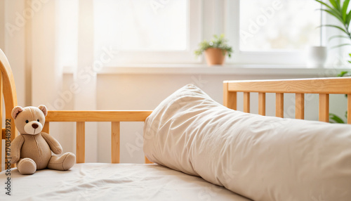Soft bumper crib with teddy bear in minimalist nursery, comfort concept