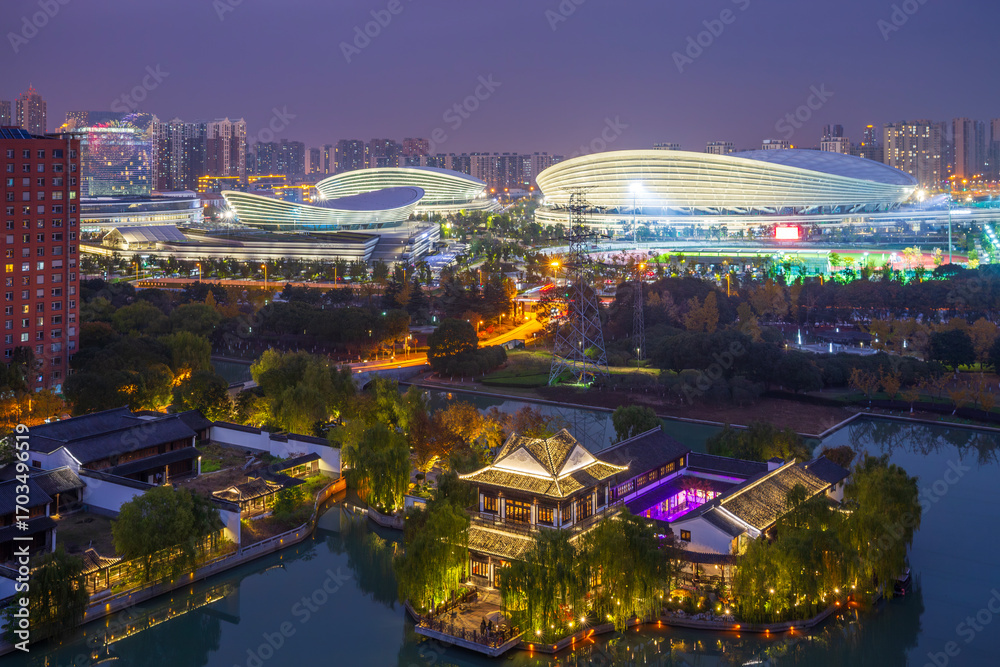 Fototapeta premium Suzhou Xietang Old Street and Olympic Sports Center ancient and modern architecture night view, China