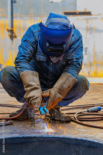 Welding male worker metal is part of machinery plate bottom tank sump construction