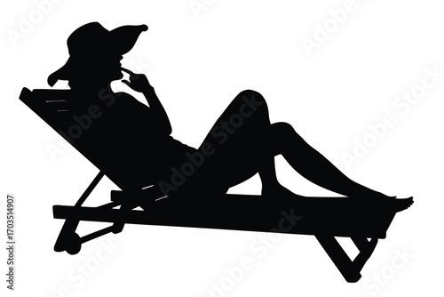 Silhouette of a woman in a hat relaxing on a beach chair thoughtfully