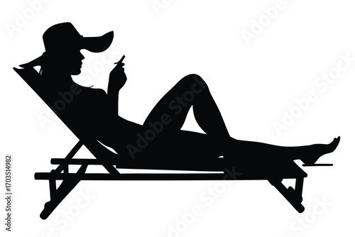 Silhouette of woman wearing a hat and sunglasses while relaxing on a deck chair