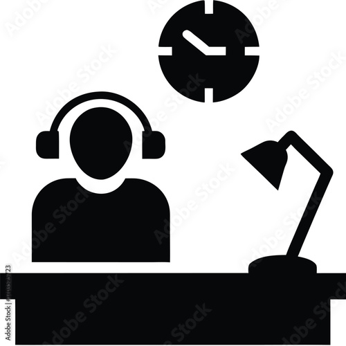 Silhouette person sits at a desk with headphones, clock, and lamp above