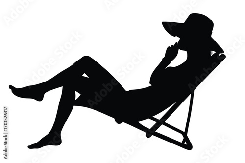 Silhouette of woman wearing sunhat relaxing on beach chair with finger on face