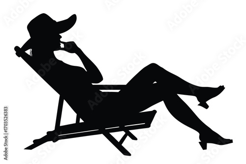 Silhouette of a woman with hat relaxing on beach chair in heels