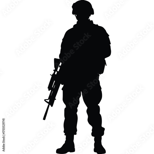 Dark silhouette of a soldier standing guard with rifle in his hands, facing forward