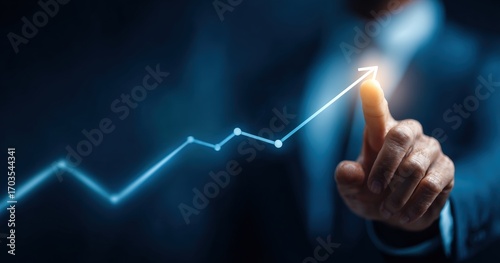 Businessman pointing to a rising graph