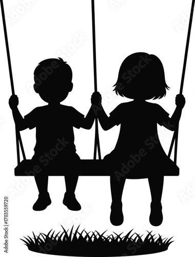 Silhouette of two children holding hands while swinging together on a swing set