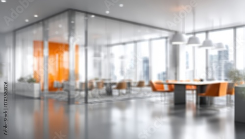 Modern, bright office interior with glass partitions and orange accents