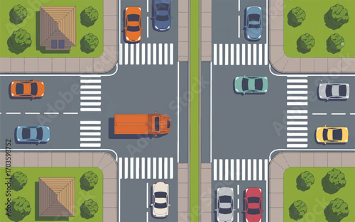 Aerial view of a busy city intersection with cars and pedestrian crossings traffic