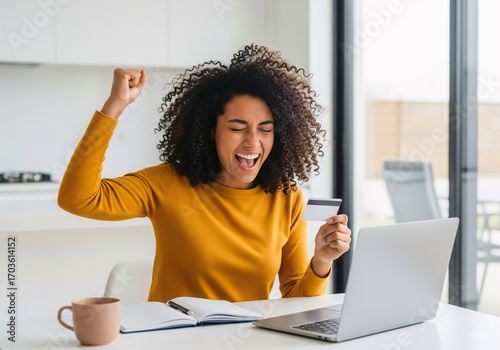 Online Purchase Joy: An individual is ecstatic, with hand-raised and card held.