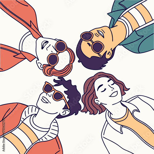 Diverse group of young friends wearing sunglasses lying down together in a circle enjoying a sunny day