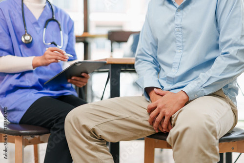 Papier peint Young man holding groin in medical consultation testicular cancer awareness and